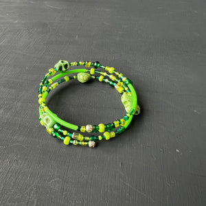Green memory wire bracelet with skulls