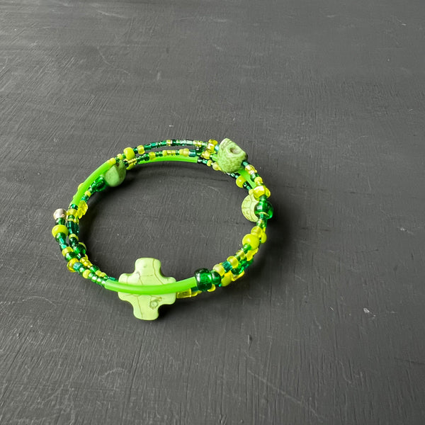 Green memory wire bracelet with skulls