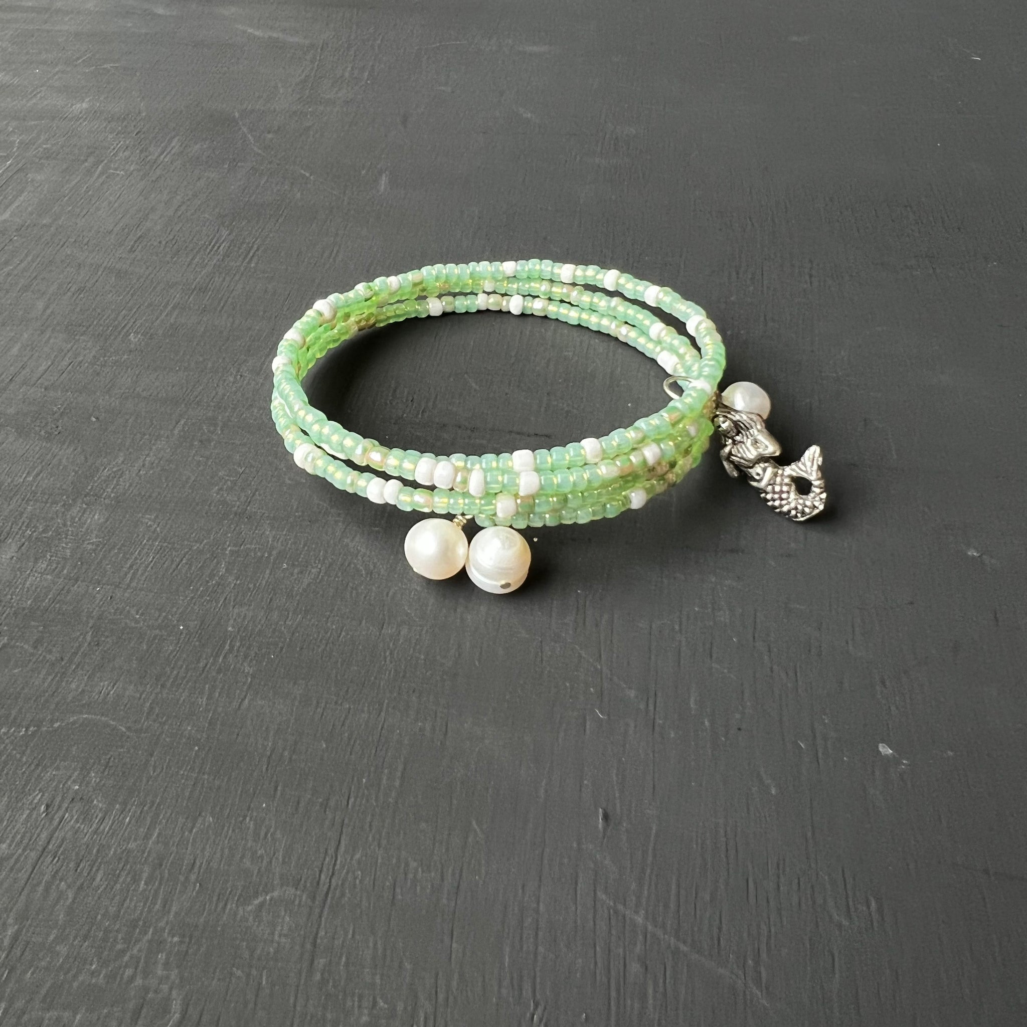 Light green memory wire bracelet with mermaid and pearls
